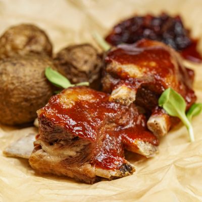 Pork Ribs TequilaBBQ, With Baked Potatoes And Caramelized Onions